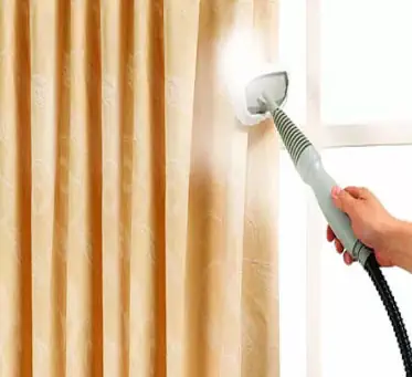 Steam cleaning drapes in a home in Darwin